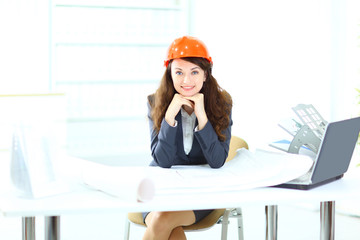 Beautiful businesswoman engineer with the work-