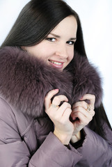 Portrait of the beautiful girl with fur