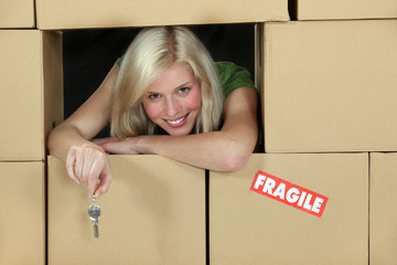 Woman surrounded by cardboard boxes