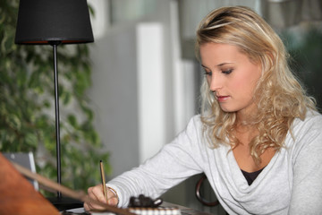 Young woman student doing homework