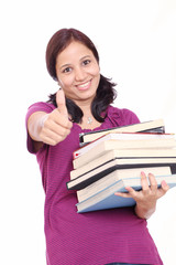 Successful female student giving thumb-up gesture