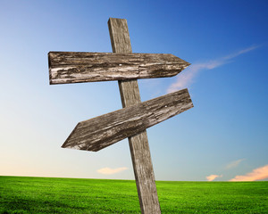 Blank road signs against blue sky