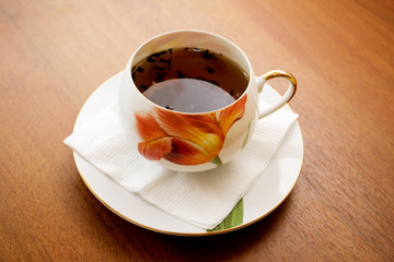 porcelain teacup and saucer on a wooden table