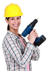 Female construction worker holding a drill