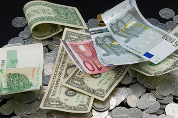 Several different banknotes on the coins background.