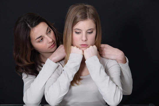 A Teenage Girl Trying To Cheer Up Her Friend.