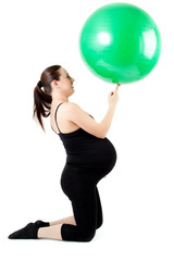 Pregnant woman excercises with gymnastic ball. Beautiful pregnan