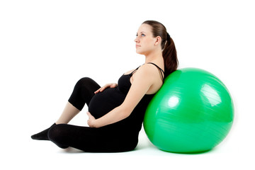 Fototapeta na wymiar Pregnant woman excercises with gymnastic ball. Beautiful pregnan