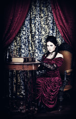 A portrait of the girl in Gothic style with the book in hands