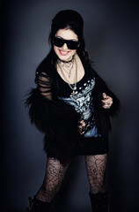 Fashion style photo of young woman in studio  in black dress