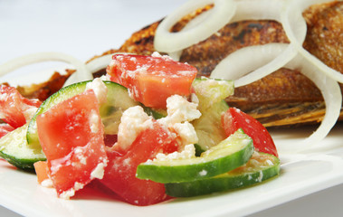 cooked fish with salad