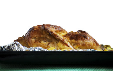 Roast chicken with potatoes, isolated on white background