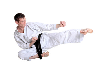 Karate jump against white background