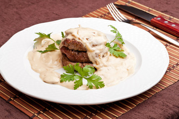 Roasted meat under white sauce