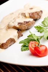 Roasted meat under white sauce