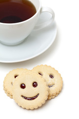 cup of tea and smiling cookies