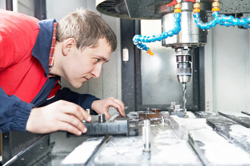 worker operating CNC machine center