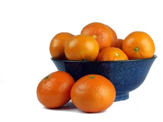 Oranges presented in a ceramic blue bowl
