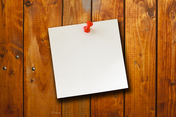 blank paper note on wood board background