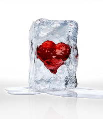 Red heart into an ice brick, over a white surface with some wate