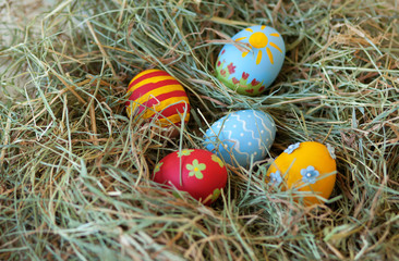 Painted colorful Easter eggs in hay