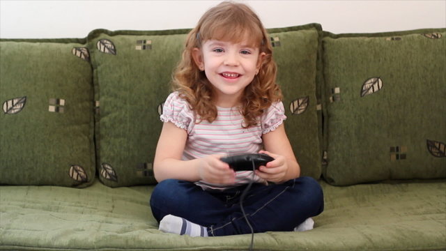 happy little girl play video game