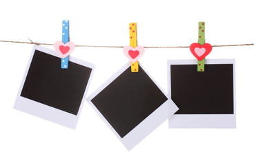 Photo paper hanging on the clothesline isolated on white