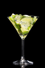 glass of cocktail with lime and mint on black background