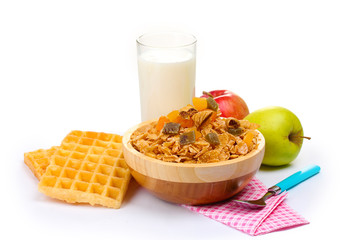 tasty cornflakes in wooden bowl, apples and glass of milk
