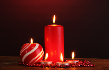 Wonderful candles on wooden table on dark background