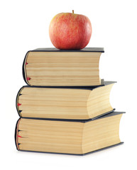 Stack of books and apple isolated on white