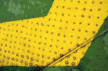 Green yellow paint metal floor closeup background