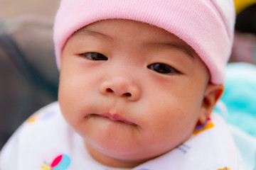 Asian baby bite her lip