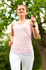 Fototapeta premium young woman running in park