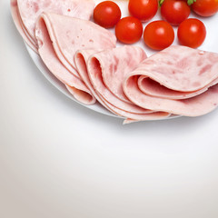 some ham slices on plate with tomatoes