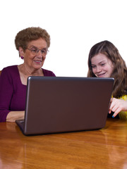 granddaughter and grandmother at a laptop