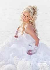 Fototapeta na wymiar Beautiful bride in the winter forest. Beautiful blonde.