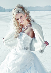 Beautiful bride in the winter forest. Beautiful blonde.