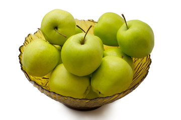 green apples in a glass vase on a white background