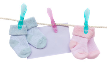 baby blue and pink socks with blank envelope  on white