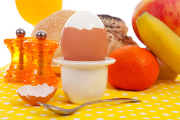 Breakfast with peeled egg, delicious bread and fruits