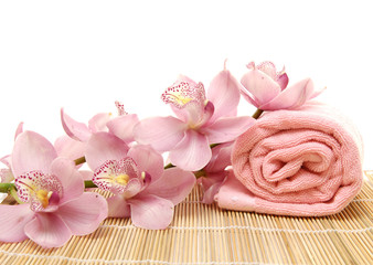 branch pink orchid and towel on mat