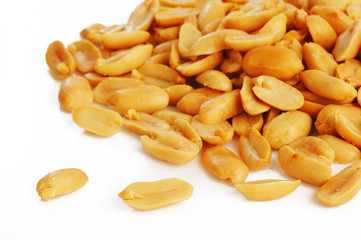 salted peanuts on white background