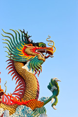 Fototapeta na wymiar Golden dragon statue and blue sky