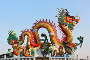 Fototapeta premium Golden dragon statue and blue sky