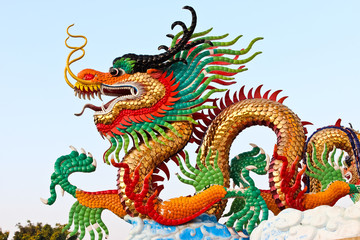 Golden dragon statue and blue sky