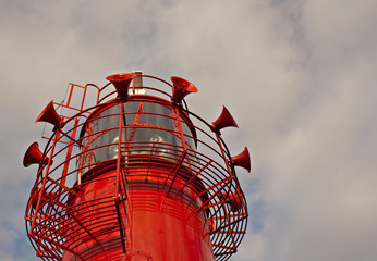 Bright red lighthouse with fog horns