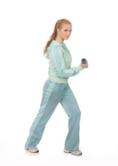 A young blond woman in sporty clothes holding a dumbbell