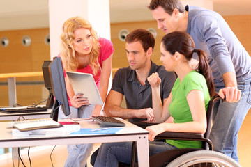 Woman in wheelchair attending group meeting