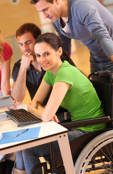 Woman in wheelchair attending group meeting